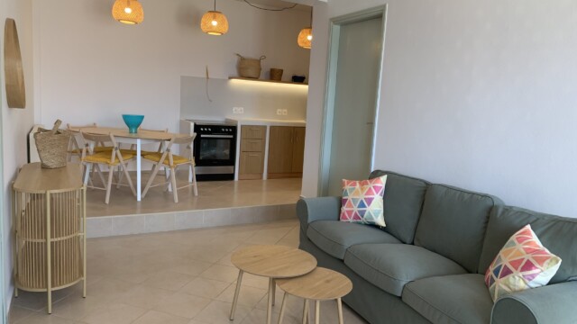 Living room with 3 seater sofa and airconditioning